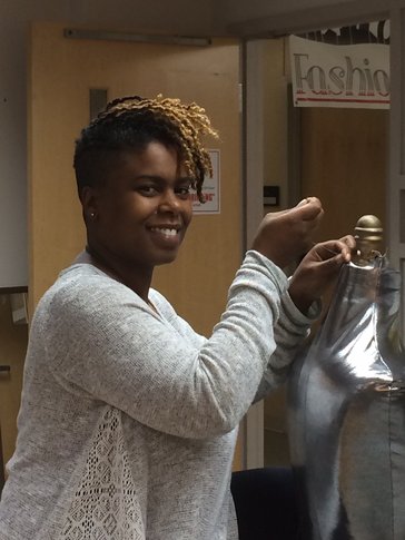 Valencia James stitching a dress.
