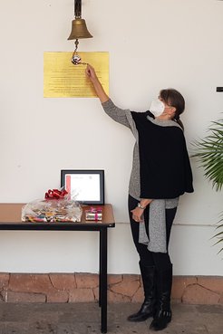 Jean Seigle ringing the PC/Mexico bell upon her retirement in February 2021