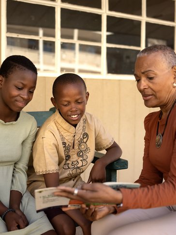 Joan with two of her young learners.