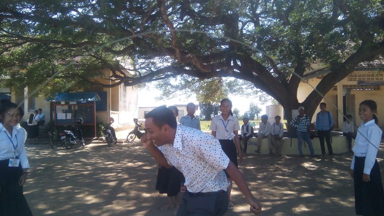 Jeevan Narney jumps rope with students in a playground in Cambodia.