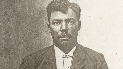 Old black and white portrait photo of a black male