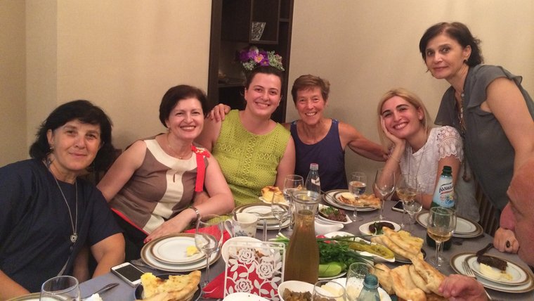 6 women sitting around a dinner time