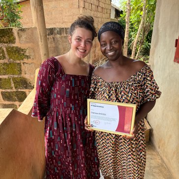 Katie presents her counterpart, Clarisse, with a certificate of appreciation, and marking the end of their time working together.