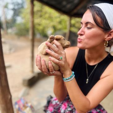 Kelcey shares a moment with a newborn puppy in Togo.
