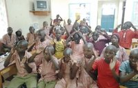 A dozen Deaf students in Kenya gather to sign to a computer