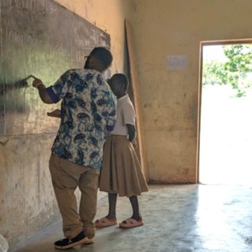 Kijana with a Togolese student in the classroom.