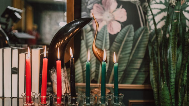 A kinara with lit candles