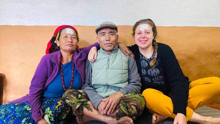 Peace Corps Volunteer Kindness H. with her host family