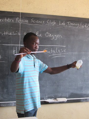 Individual in front of black board
