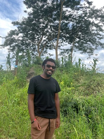 Kyle relaxes in his community in Uganda.
