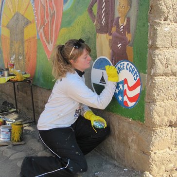 Laura works on the Peace Corps mural.