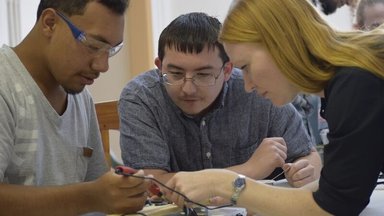 ASU team train youth in assembly of SolarSPELL device