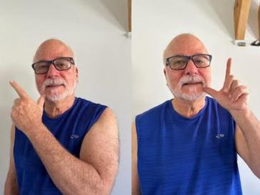 A man swipes his thumb across his chin from left to right