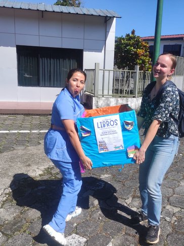 Carrying boxes of books to a newly restored library and park in Ecuador.
