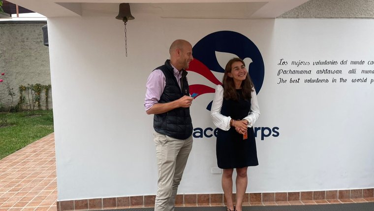Lidia rings Peace Corps Peru's bell, marking the completion of her Volunteer service.