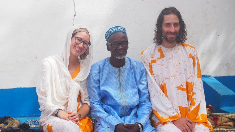 Mack, his wife Ellie and their host father in The Gambia.