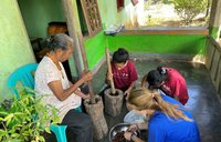 Maggie preparing food with locals in Indonesia