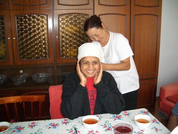 Mahima's host mom ties a customary scarf on her mom during her family's visit in Kyrgyzstan.
