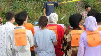 Group of students looking at individual