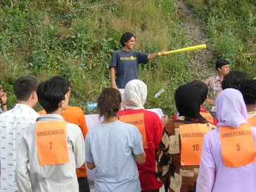 Group of students looking at individual