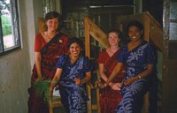 Four District English Language Improvement Center teachers pause for a photo in their matching kandyan sarees.