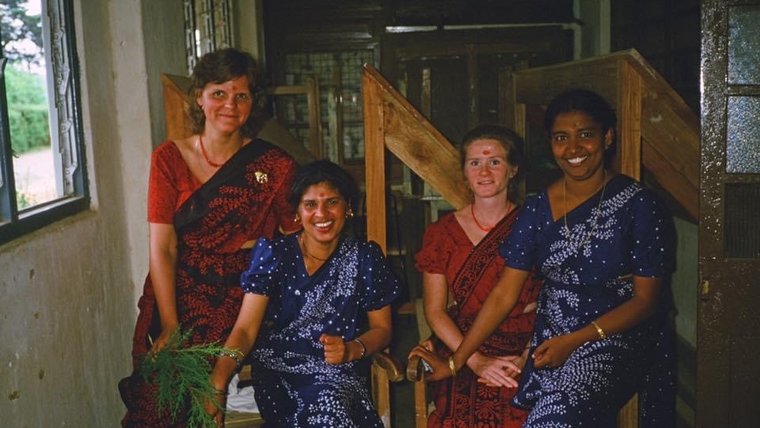 Four District English Language Improvement Center teachers pause for a photo in their matching kandyan sarees.