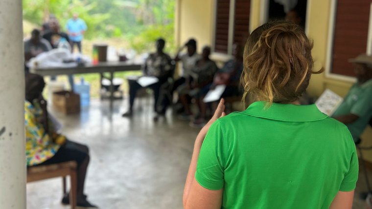 Marie presents at a farmers’ group meeting in Jamaica.