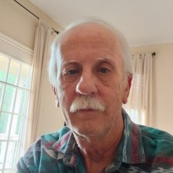 A selfie of an older man with a mustache