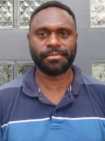A headshot of a man not smiling