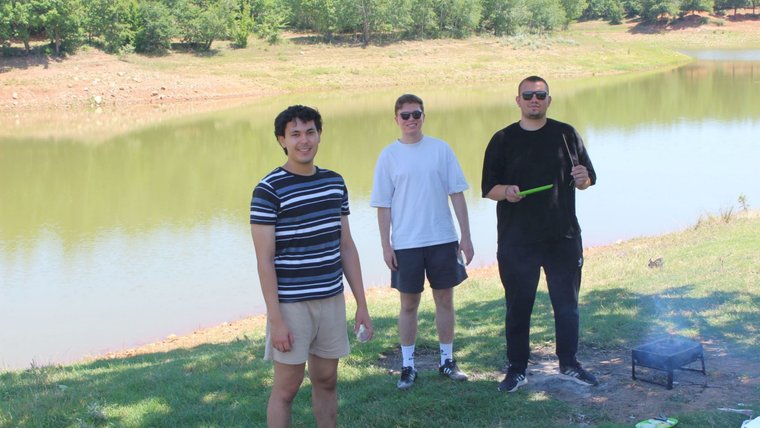 Max enjoys a barbecue with a group of friends by a lake in North Macedonia.