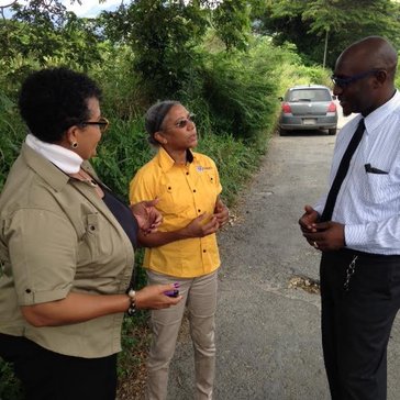 Three people on the side of the road talking