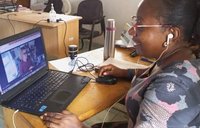 A woman has a virtual meeting on her computer