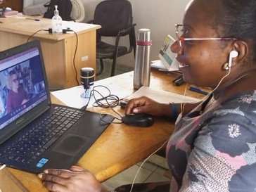 A woman has a virtual meeting on her computer