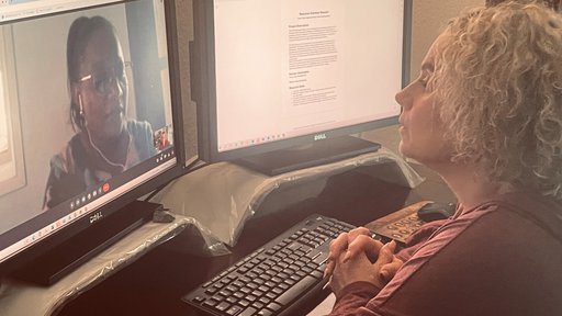 A blonde woman does a virtual meeting on her computer