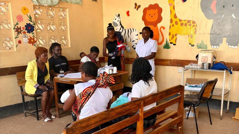 Meleki delivers a health talk about HIV/AIDS at an under-5 clinic in Zambia.