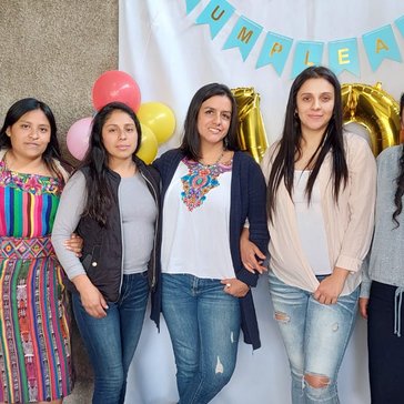The Mujeres Mejorando Vidas staff in Guatemala gather to celebrate