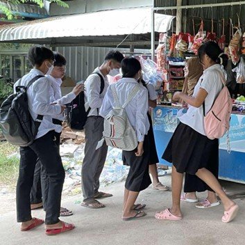 10th graders interview vendors in order to identify challenges in a Cambodian community.