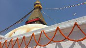 A close up shot of a Nepal temple tower with prayer flags