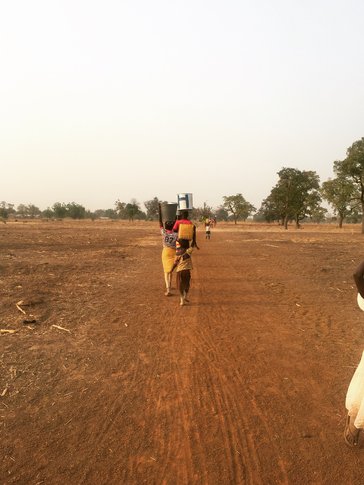 Women and children haul water from the river to Keisha’s community, 30 minutes away.