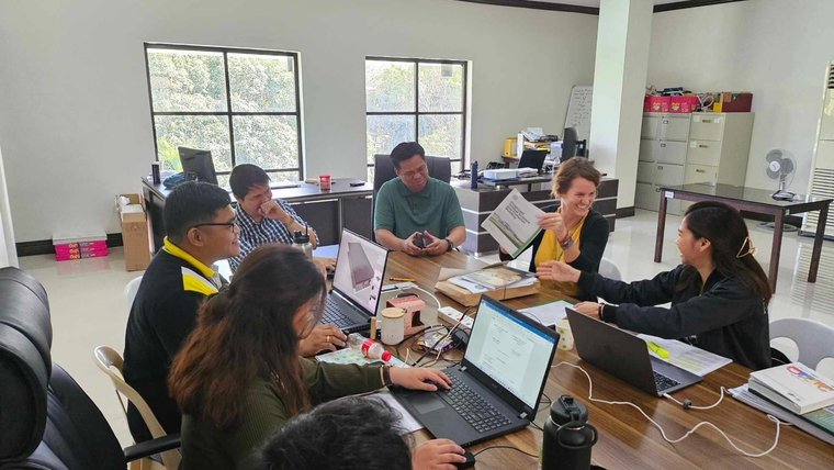 Julie engages with her Filipino partners during a strategic planning session.