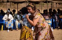 Peace Corps Malawi Volunteer running to hug her host mother
