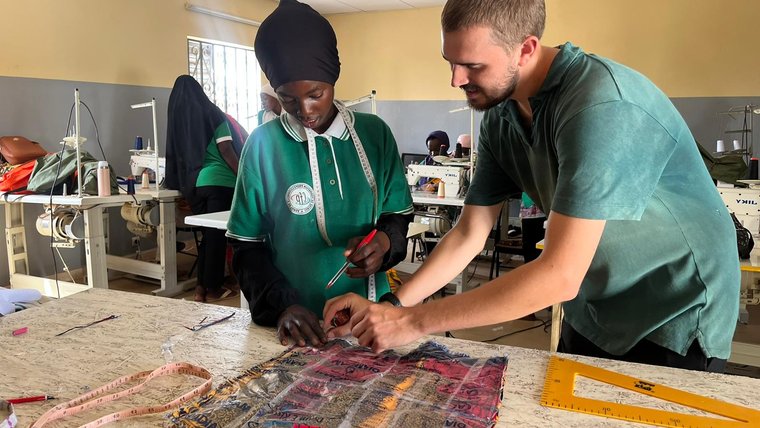 Volunteer Holden assists a workshop participant.