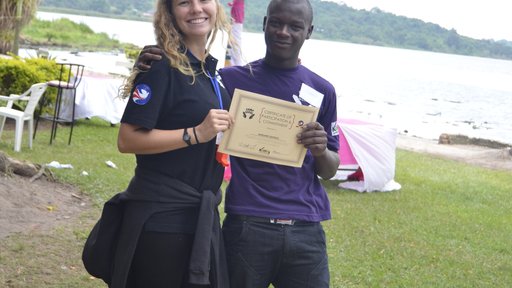 Volunteer Katie Fox awards a certificate to a camp participant.