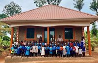 PCV Liz, teachers and pupils in front of the completed library
