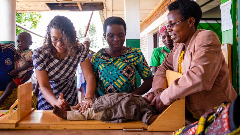 PCV Maya, counterpart, and mother measure length of baby