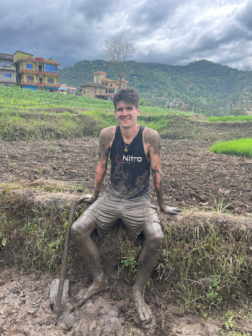 Steven after helping his host family prepare their rice paddy for planting.