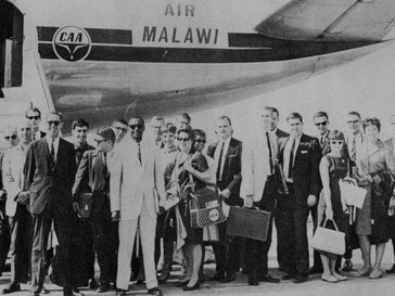 Peace Corps Volunteers arrive in Malawi (1964) under the leadership of Country Director James Blackwell (center-left in the white suit).