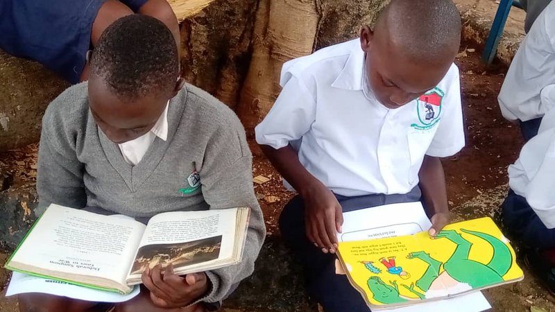 Ugandan children reading on DEAR Day