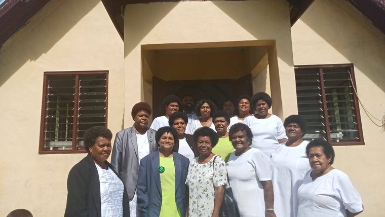 women in front of building