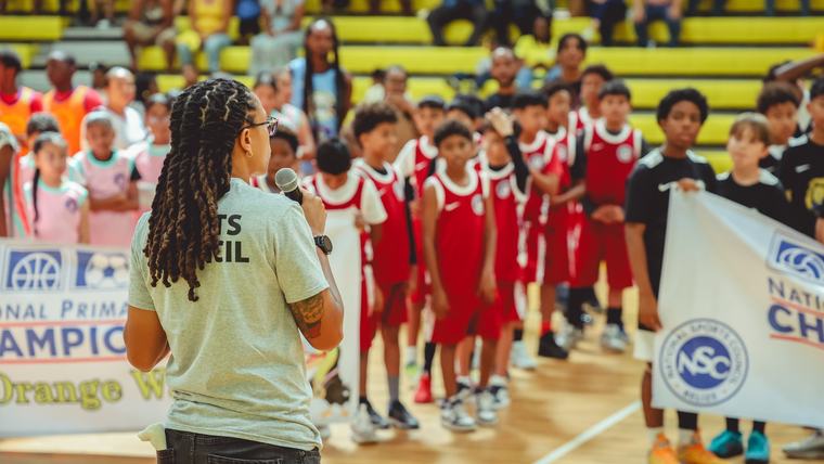 teacher speaking to student atheletes